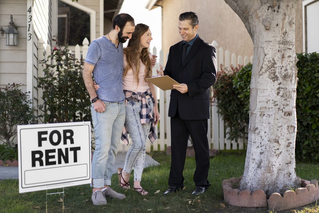 couple signing papers fr new house